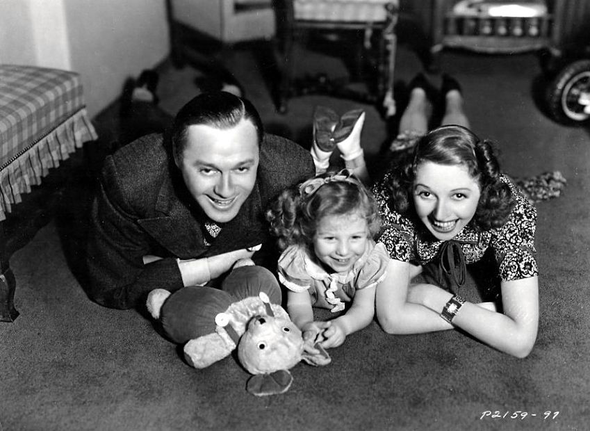 Vintage family portrait: parents and child smiling