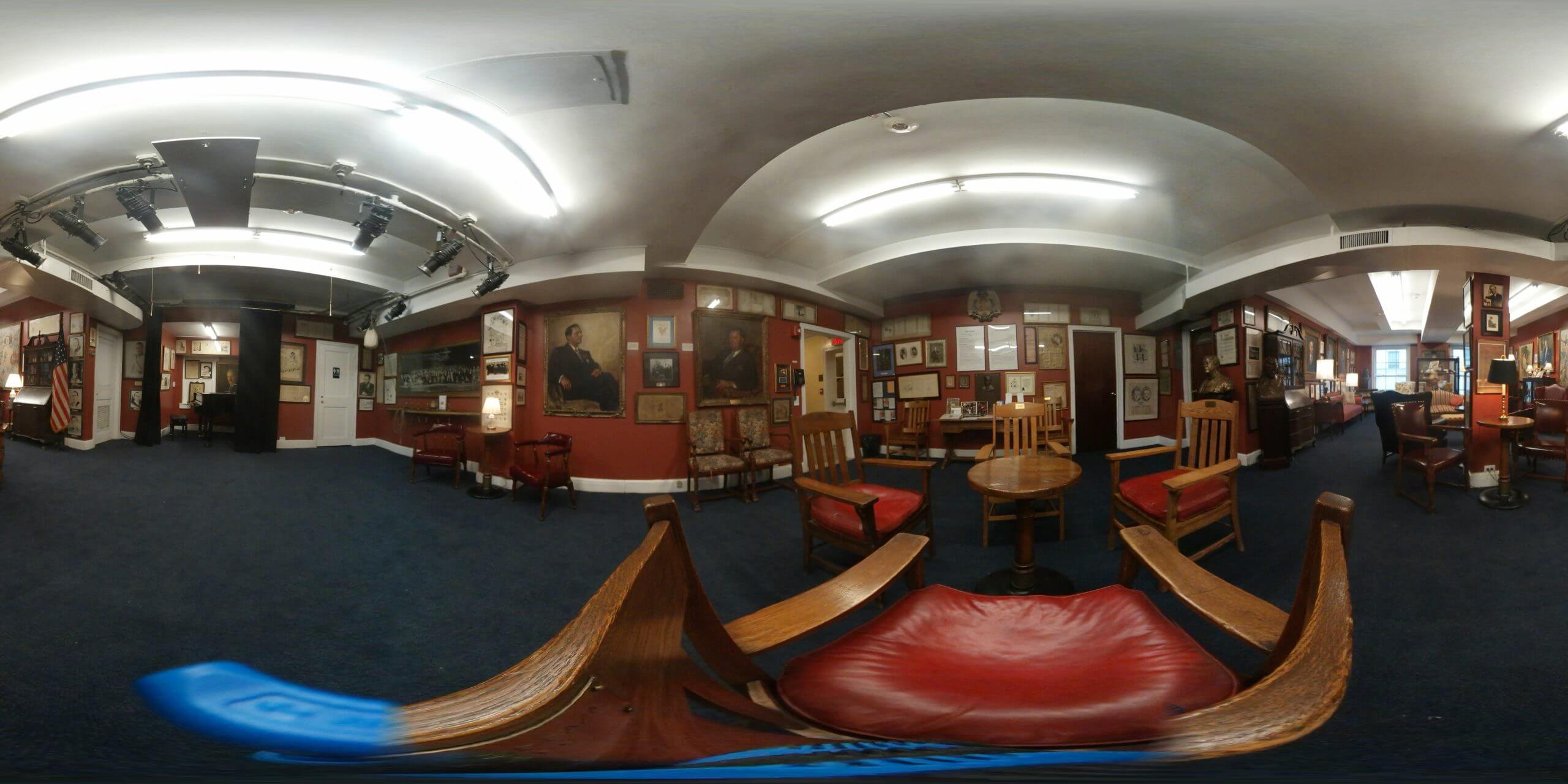 Panoramic view of vintage clubroom with portraits