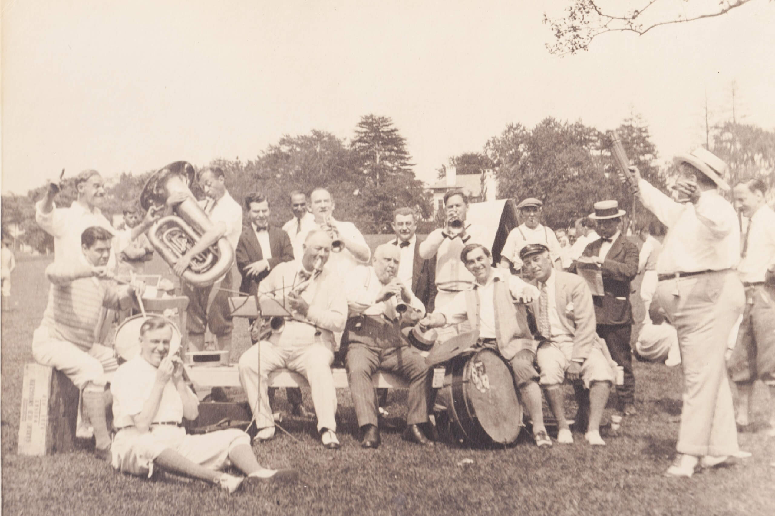 Group of musicians playing outdoors in park.